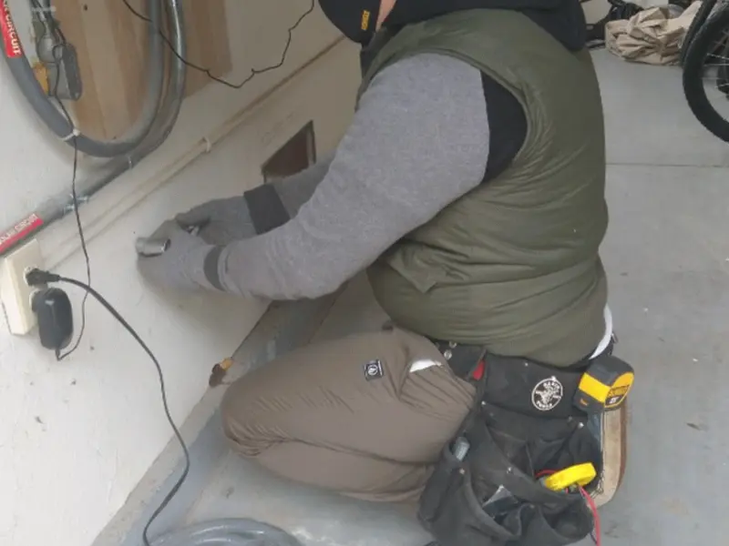Electrician performing outlet wiring in a Santa Rosa garage